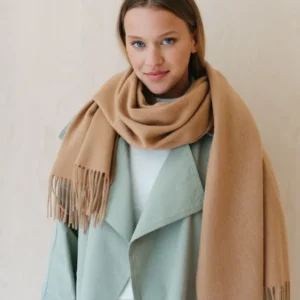 TBCo Lambswool Oversized Scarf in Camel styled with mint green coat, showcasing fringed ends and luxurious draping