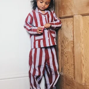 Child wearing TBCo Cotton Kids Pyjamas in Lilac Stripe with pockets, made from 100% cotton for cosy comfort.