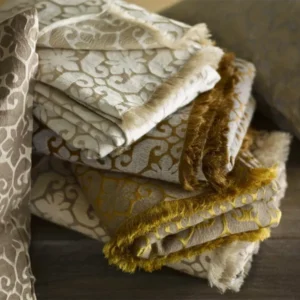 SDH Salon Ankara decorative pillows stacked, damask pattern in taupe and gold tones.